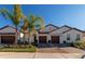 Three-unit building with attached garages and landscaping at 17322 Holly Well Ave, Wimauma, FL 33598