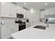 Bright kitchen featuring white cabinets, stainless steel appliances, and a quartz island at 17322 Holly Well Ave, Wimauma, FL 33598