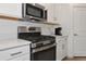 Stainless steel appliances and white cabinets in modern kitchen at 17322 Holly Well Ave, Wimauma, FL 33598