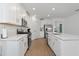 Modern kitchen with white cabinets, stainless steel appliances, and an island at 17322 Holly Well Ave, Wimauma, FL 33598