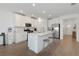 Modern kitchen with white cabinets, quartz countertops, and island at 17322 Holly Well Ave, Wimauma, FL 33598