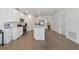 Modern kitchen with white cabinets, quartz countertops, and island at 17322 Holly Well Ave, Wimauma, FL 33598