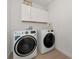 Laundry room with white cabinets and washer and dryer at 17322 Holly Well Ave, Wimauma, FL 33598