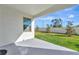 Covered patio overlooks a fenced backyard with grassy lawn at 17322 Holly Well Ave, Wimauma, FL 33598