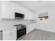 Modern kitchen with white cabinets, stainless steel appliances, and quartz countertops at 1848 Scarlett Ave, North Port, FL 34289