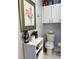 Clean bathroom with toilet, vanity, and overhead cabinets at 2220 Stickney Point Rd # 537, Sarasota, FL 34231