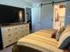 Bright bedroom with large TV and barn door to en-suite bathroom at 2220 Stickney Point Rd # 537, Sarasota, FL 34231