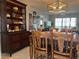 Spacious dining area, featuring a wood table with chairs and a hutch at 2220 Stickney Point Rd # 537, Sarasota, FL 34231