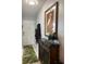 Bright entryway with decorative storage cabinet and wood flooring at 2220 Stickney Point Rd # 537, Sarasota, FL 34231
