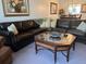 Living room with leather sectional and coffee table at 2220 Stickney Point Rd # 537, Sarasota, FL 34231