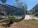Community pool with screened enclosure and lounge chairs at 2220 Stickney Point Rd # 537, Sarasota, FL 34231