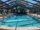 Inviting community swimming pool under a screened enclosure at 2220 Stickney Point Rd # 537, Sarasota, FL 34231