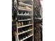 Well-organized closet with shoe shelves and hanging rods at 2220 Stickney Point Rd # 537, Sarasota, FL 34231