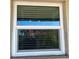 White framed window with blinds and screen at 2220 Stickney Point Rd # 537, Sarasota, FL 34231