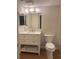 Bathroom boasts a vanity with white cabinets and a toilet at 2753 Orchid Oaks Dr # 104, Sarasota, FL 34239
