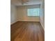 Bright bedroom with wood-look flooring and a window at 2753 Orchid Oaks Dr # 104, Sarasota, FL 34239