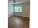 Second bedroom with wood-look floors and a window at 2753 Orchid Oaks Dr # 104, Sarasota, FL 34239