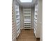 Spacious walk-in closet with ample shelving and drawers at 2753 Orchid Oaks Dr # 104, Sarasota, FL 34239