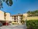 Condo building with parking and landscaping at 2753 Orchid Oaks Dr # 104, Sarasota, FL 34239