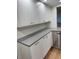 Modern kitchen features gray countertops and white cabinets at 2753 Orchid Oaks Dr # 104, Sarasota, FL 34239