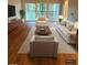 Spacious living room with hardwood floors, comfortable seating, and access to a balcony at 2753 Orchid Oaks Dr # 104, Sarasota, FL 34239