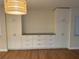 Living room with built-in cabinetry and hardwood floors at 2753 Orchid Oaks Dr # 104, Sarasota, FL 34239