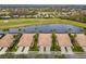 Aerial view of houses and a lake in a community at 288 Fairway Isles Ln, Bradenton, FL 34212