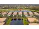 Community overview featuring houses, lake, and golf course at 288 Fairway Isles Ln, Bradenton, FL 34212