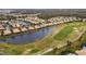 Aerial view of community with lake and golf course at 288 Fairway Isles Ln, Bradenton, FL 34212