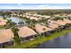 Aerial view of a luxury community with lakefront properties and lush landscaping at 288 Fairway Isles Ln, Bradenton, FL 34212