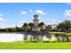 Picturesque community lake with lighthouse feature at 288 Fairway Isles Ln, Bradenton, FL 34212