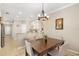 Bright dining area with a table and chairs, adjacent to a kitchen at 288 Fairway Isles Ln, Bradenton, FL 34212