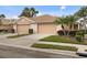 Tan house with two-car garage and landscaped yard at 288 Fairway Isles Ln, Bradenton, FL 34212