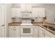 White kitchen cabinets and granite countertops at 288 Fairway Isles Ln, Bradenton, FL 34212