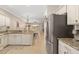 Kitchen with granite countertops, white cabinets, and stainless steel appliances at 288 Fairway Isles Ln, Bradenton, FL 34212