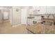 Kitchen features granite countertops and white cabinets at 288 Fairway Isles Ln, Bradenton, FL 34212