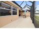 Covered patio with seating area and lake view at 288 Fairway Isles Ln, Bradenton, FL 34212