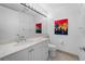 Bright bathroom with white vanity, toilet, and large mirror at 3030 Grand Bay Blvd # 396, Longboat Key, FL 34228