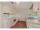 View of kitchen with white cabinets and appliances at 3131 Lockwood Ter, Sarasota, FL 34231