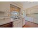 Kitchen with double sink, white cabinets, and wood floors at 3131 Lockwood Ter, Sarasota, FL 34231