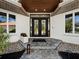 Elegant entryway with modern double doors and a stone walkway at 3178 Dick Wilson Dr, Sarasota, FL 34240