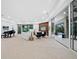 Open living space with a view of the pool and backyard through sliding doors at 3178 Dick Wilson Dr, Sarasota, FL 34240