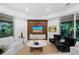 Spacious living area with large windows and a wooden feature wall at 3178 Dick Wilson Dr, Sarasota, FL 34240