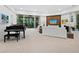 Living room with piano, large windows and access to the pool area at 3178 Dick Wilson Dr, Sarasota, FL 34240