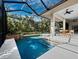 Inviting pool and spa with a screened enclosure, perfect for relaxation at 3178 Dick Wilson Dr, Sarasota, FL 34240