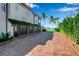 Spacious garage with brick paver driveway and lush hedges at 3500 Bayou Louise Ln, Sarasota, FL 34242