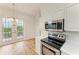 Dining area with hardwood floors and access to a private balcony at 3524 Walker Is, Bradenton, FL 34208