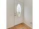 White door with oval stained glass window and wood floors at 3524 Walker Is, Bradenton, FL 34208