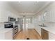 Modern kitchen with white cabinets, stainless steel appliances and hardwood floors at 3524 Walker Is, Bradenton, FL 34208