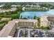 Apartment building with ample parking and a scenic lake view from an aerial perspective at 3544 Lake Bayshore Dr # K123, Bradenton, FL 34205